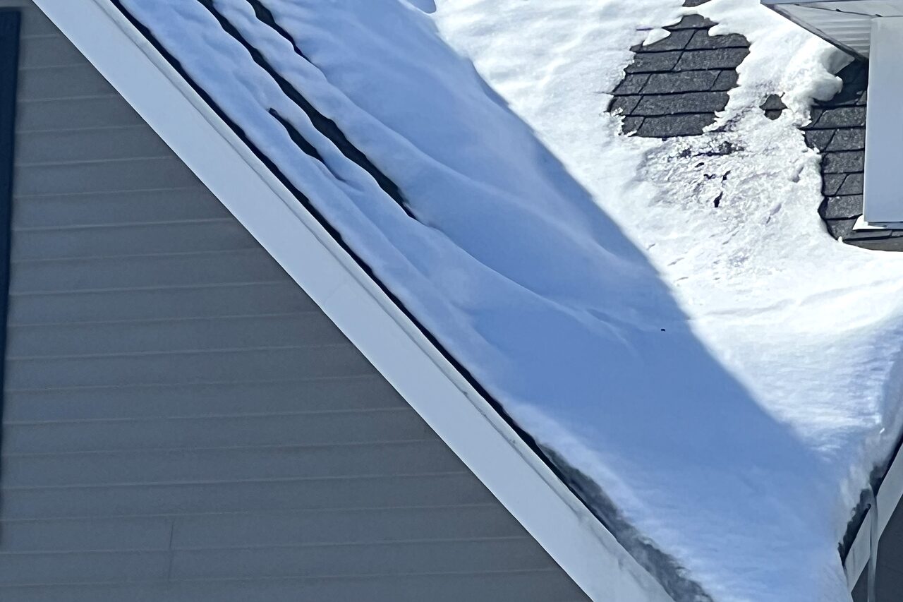 An ice dam built up along the eave of a New Hampshire home after a snowstorm