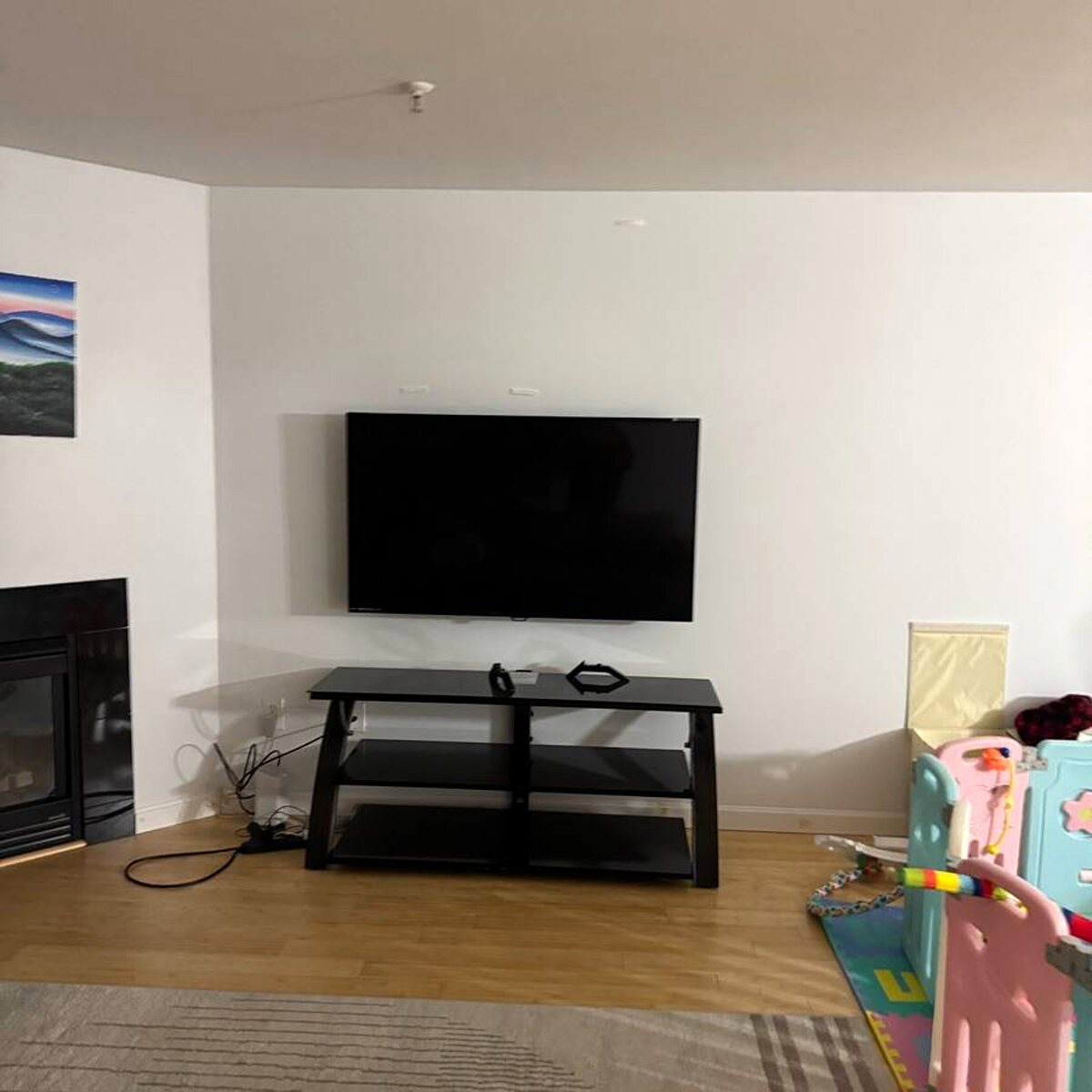 Wall-mounted TV with concealed wiring in a living room
